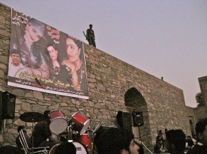 Tajik women concert banner with guard on wall Tajik women concert banner with guard on wall