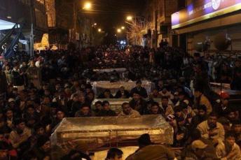 Alamdar Road, Quetta: Shia Hazara protestors sitting with coffins in the freezing cold.