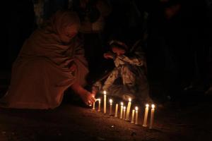 Grieving women light candles at the ongoing dharna in Quetta