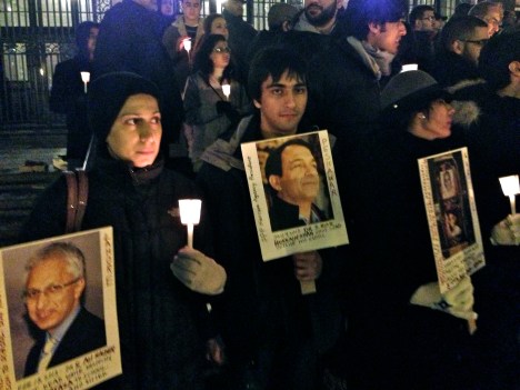 Syed Shehroz Hussain (centre) holds a picture of his father, Dr Riaz Hussain Shah who was killed in Peshawar recently.