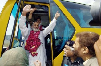 April 7, 2005: Pakistani passengers wave as they board the first bus heading to Srinagar from Muzaffarabad, the first bus service to link divided Kashmir in nearly 60 years. Photo: Jewel Samad/AFP/Getty Images