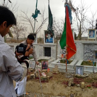 At the Hazara graveyard in Quetta: Agha Mujtaba practices walking, Anas filming him