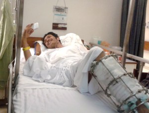 April 2014: Skyping with his family in Quetta, amputee Zakir Hussain flashes a cheerful smile from his hospital bed in Karachi.