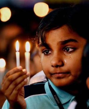 A student in Chennai prays for those killed in Peshawar. Schools across India held a two-minute silence on Wednesday. Photo: R. Senthil Kumar/ PTI